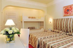 Rúm í herbergi á Park Hotel Villaferrata