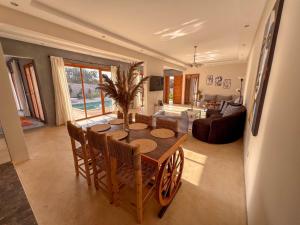 a living room with a wooden table and chairs at Villa Amwaj 15 min from Essaouira & Sidi Kaouki in Essaouira