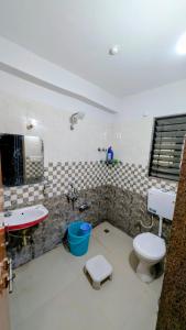 a bathroom with a toilet and a sink and a tub at Jalsa Home Stay in Sheoganj +12 photos