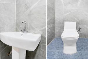 a bathroom with a white toilet and a sink at Collection O Vrindavan Yojna Lucknow Formerly Khushboo Palace in Nilmatha