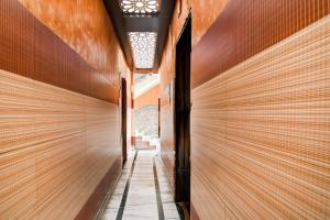 a hallway of a building with wooden walls at Super Collection O New Jalpaiguri Railway Station Formerly Prince Lodge in Siliguri