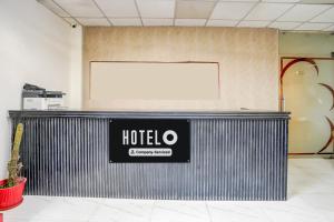 a hotel sign on a metal wall in a room at Super Hotel O Sector 51 Metro Station Formerly Shubham Residency in Indirapuram