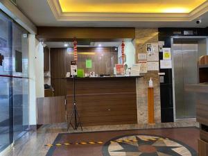 a lobby with a counter in a building at Darlene Hotel in Singapore