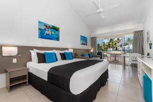 a bedroom with a large bed in a room at By The Sea Port Douglas in Port Douglas +39 photos