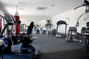 a gym with several treadmills and cardio machines at Barefoot Bliss in Rockingham