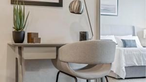 a desk with a chair next to a bed at Landing Amazing 1BD Clubhouse Pool in Oxford