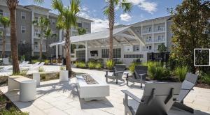 a courtyard with tables and chairs in front of a building at Landing Amazing 1BD Clubhouse Pool in Oxford