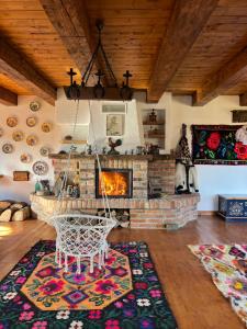 a living room with a fireplace and a swing at La Patru Daci in Ocna Şugatag