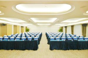 a room with blue and white chairs in it at M Hotel Shenzhen Nanshan in Shenzhen