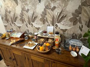 a table with food and other food items on it at Auberge de Lamagistere in Lamagistère