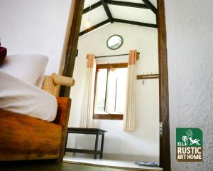 a bedroom with a bed with a mirror and a window at Ella Rustic Art Home in Badulla