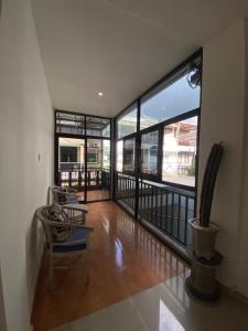 a room with large windows and a table and a chair at Uma Luhur Villa in Ungasan