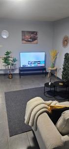 TV a/nebo společenská místnost v ubytování B&B Evasion Appartment