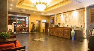 a lobby with a bar in a restaurant with a christmas tree at James Joyce Coffetel Xian Dayanta Metro Station Branch in Xi'an