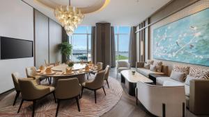 a dining room with a table and chairs at Crowne Plaza Weihai Binhai by IHG in Weihai