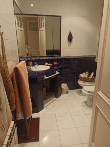 a bathroom with a sink and a toilet and a mirror at apartamento céntrico zona Marques de comillas 8 in Laredo +51 photos