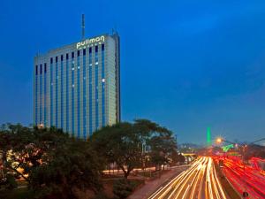 a building with a sign on the top of it at Pullman Sao Paulo Ibirapuera in Sao Paulo