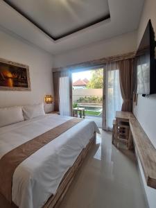 a bedroom with a large bed and a large window at Casa Benoa Homestay in Nusa Dua +22 photos