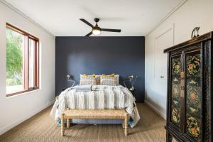 a bedroom with a bed and a ceiling fan at Whistlewood - Stunning Views in the Adelaide Hills in Upper Sturt