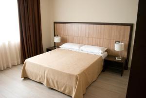 Postel nebo postele na pokoji v ubytování Galileo B&B