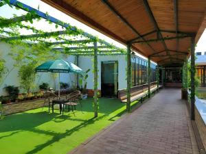 a covered patio with a table and an umbrella at GreenTree Inn Nanjing Software Valley DaDingFang Express Hotel in Nanjing