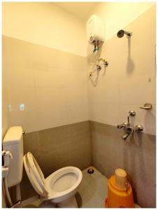 a bathroom with a toilet and a shower at Hotel Blusesagar Residency Near Sea Beach And Jagannath Temple in Puri +15 photos