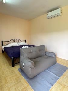 a living room with a couch and a bed at Mood Resotel Kamala in Kamala Beach