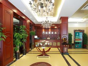 a lobby with a table and a chandelier at GreenTree Inn Hefei Chenghuangmiao San Xiao Kou Subway Station Hotel in Hefei