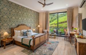 a bedroom with a bed and a large window at Villasita Udaipur in Udaipur +41 photos