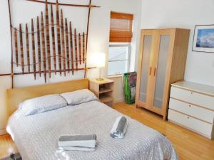 a small bedroom with a bed and a dresser at Best Location In South Beach Steps To Everything! in Miami Beach +15 photos