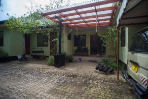 a patio of a house with a pergola at Arusha Giraffe Lodge in Arusha