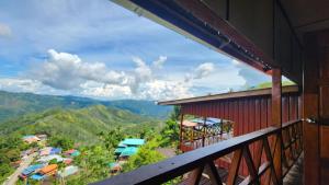 a balcony of a building with a view of a city at Kiau View Cabin in Kota Belud