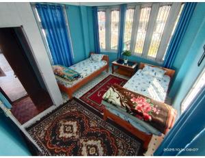 a living room with a couch and a chair at Ngima woizer Homestay,Tawang in Tawang