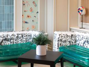 a living room with two chairs and a table at Mercure Grenoble Centre Porte des Alpes in Grenoble