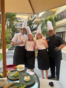 a group of people wearing chefs hats holding up certificates at Kuta Town House Apartments in Kuta +64 photos