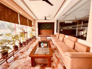 a living room with a couch and a coffee table at Hotel Amritsar View with Swimming Pool - Best Selling Hotel in Amritsar near Golden Temple in Amritsar
