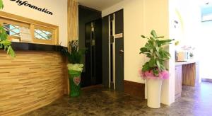 a hallway with two potted plants in a building at Java Hotel in Daejeon