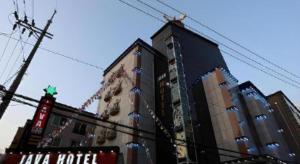 a tall building with christmas decorations in front of it at Java Hotel in Daejeon