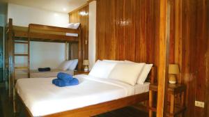 a bedroom with two bunk beds with a blue elephant on the bed at Seaside Beach Hostel in San Vicente