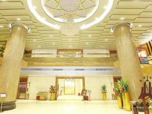 a lobby with columns and a chandelier in a building at Borrman Hotel Guangzhou Tianhe Tangdong Subway Station Convention and Exhibition Center in Guangzhou