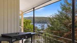 a balcony with a grill and a view of the water at 'Horizons On Heath' by HolidayCo in Hardys Bay +14 photos