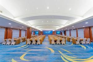 una gran sala con filas de mesas y sillas en Huizhou Wanyun Holiday Hotel, en Huangshan