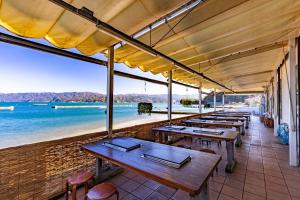 a row of tables in a restaurant overlooking the beach at Tsuruga Sazanami Resort Chobei in Tsuruga