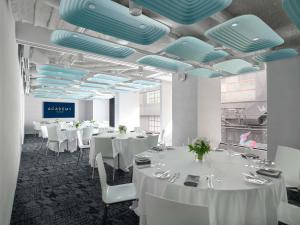 a dining room with white tables and blue ceilings at Mercure Welcome Melbourne in Melbourne +55 photos