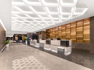 a lobby of a hotel with a reception desk at Novotel Atlantis Shanghai - Enjoy our great-valued breakfast in our rooftop revolving restaurant with a stunning river view & utilize our FREE self-serviced laundry in Shanghai