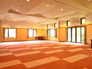 a large room with a checkered floor and windows at 苗場ビレッヂ in Yuzawa +24 photos
