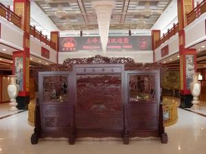 a store with two wooden doors in a building at Wutaishan Wufeng Hotel in Wutai