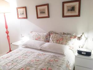 a bedroom with a bed and two pictures on the wall at Cà Farnese in Venice