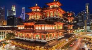 a large building with a tower in a city at Capsule@Hive Bugis in Singapore