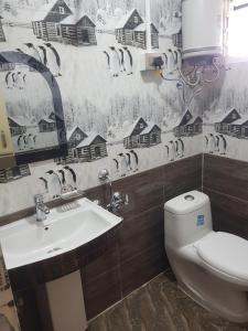 a bathroom with a toilet and a sink at Mannata Homesaty in Darjeeling +14 photos